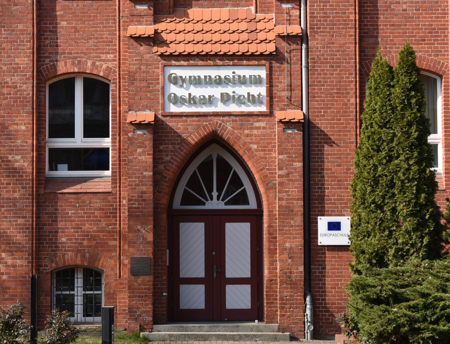 Eingangsportal des Oskar-Picht-Gymnasiums aus rotem Backstein
